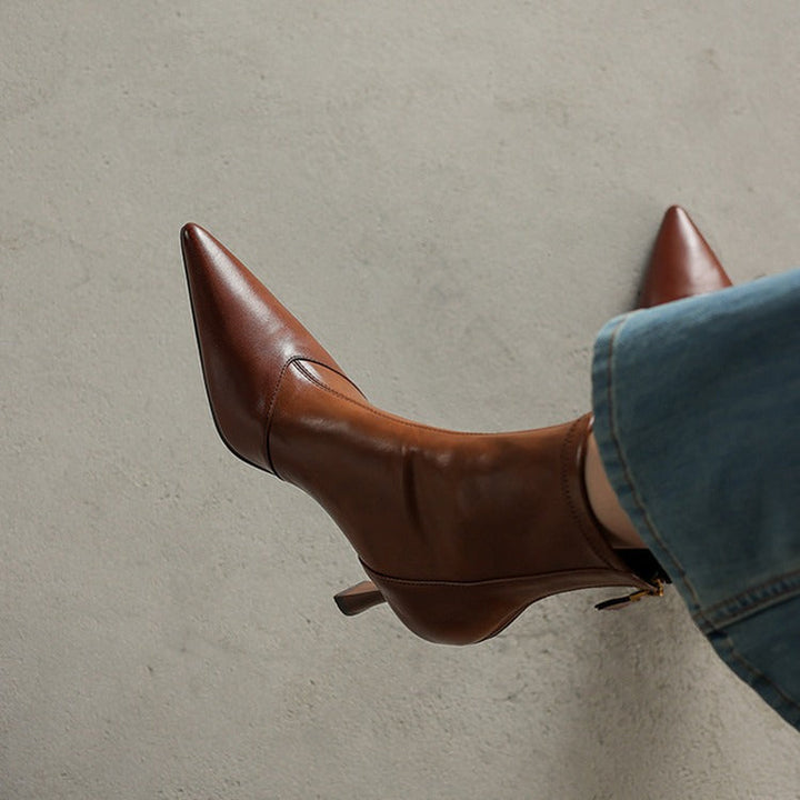 Chic brown heeled boots with a pointed toe, designed for women seeking a confident and stylish look.