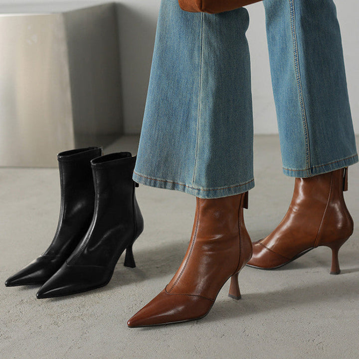 Dressy women's pointed-toe heeled boots, offering sophisticated and confident style, available in black.