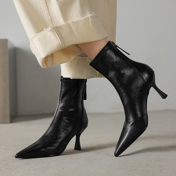 Confident style women's pointed-toe heeled boots in black, perfect for elegant and modern ensembles.