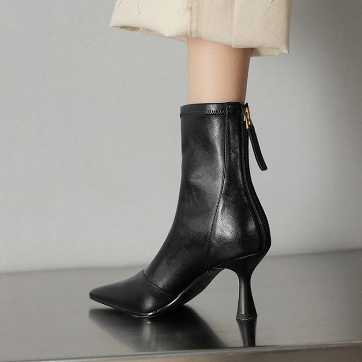 Sleek black women's heeled boots with a pointed toe, bringing fashion and confidence to your wardrobe.