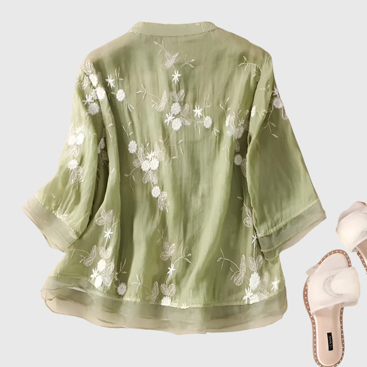 Stylish women's floral embroidered top, elegant & comfortable for spring/summer fashion. Relaxed fit.