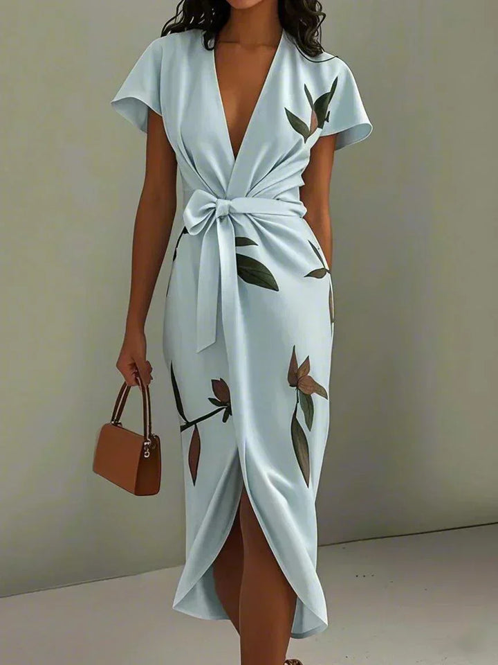 Chic women's floral midi dress, perfect for summer garden parties, featuring flutter sleeves & bow detail.