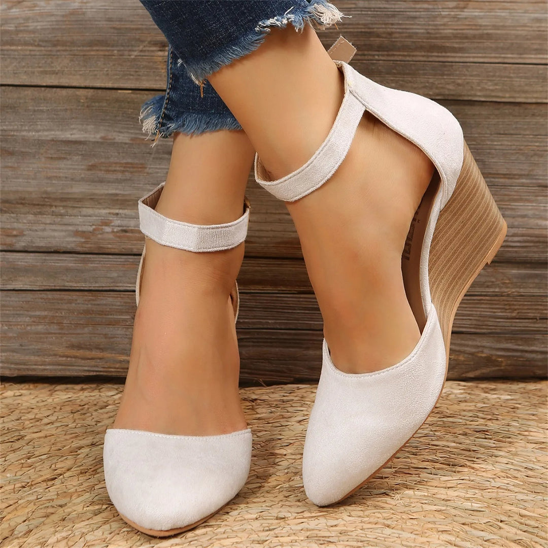 Elegant women's closed-toe wedge heels with a comfortable ankle strap. Perfect for dressy occasions.