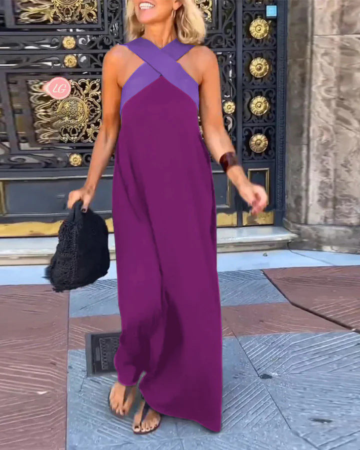 Detail of the luxurious flowy fabric of an elegant women's cross neck maxi dress. Summer evening wear.
