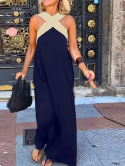 Model showcasing a women's elegant cross neck flowy maxi dress. Perfect day to night versatile fashion.