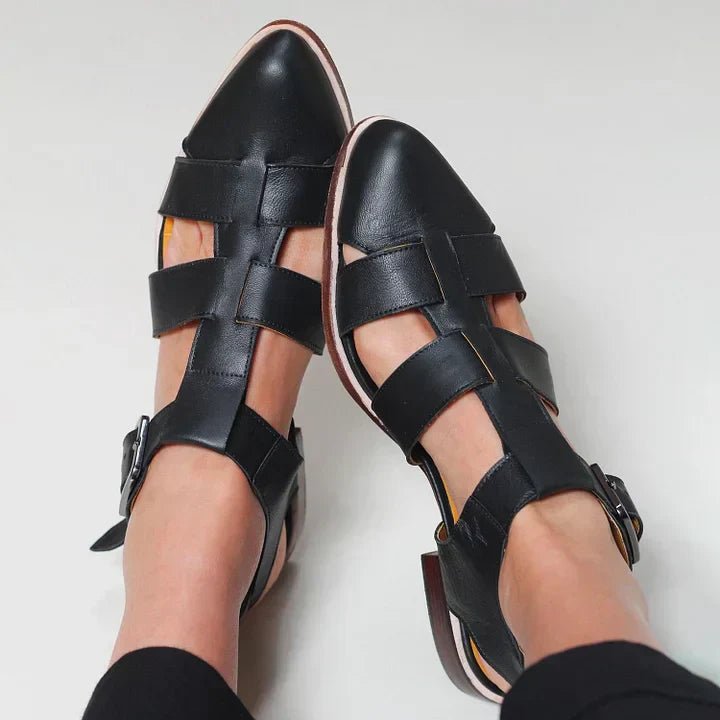 Classic black women's elegant flat sandals with comfortable straps. Versatile slip-on casual footwear.