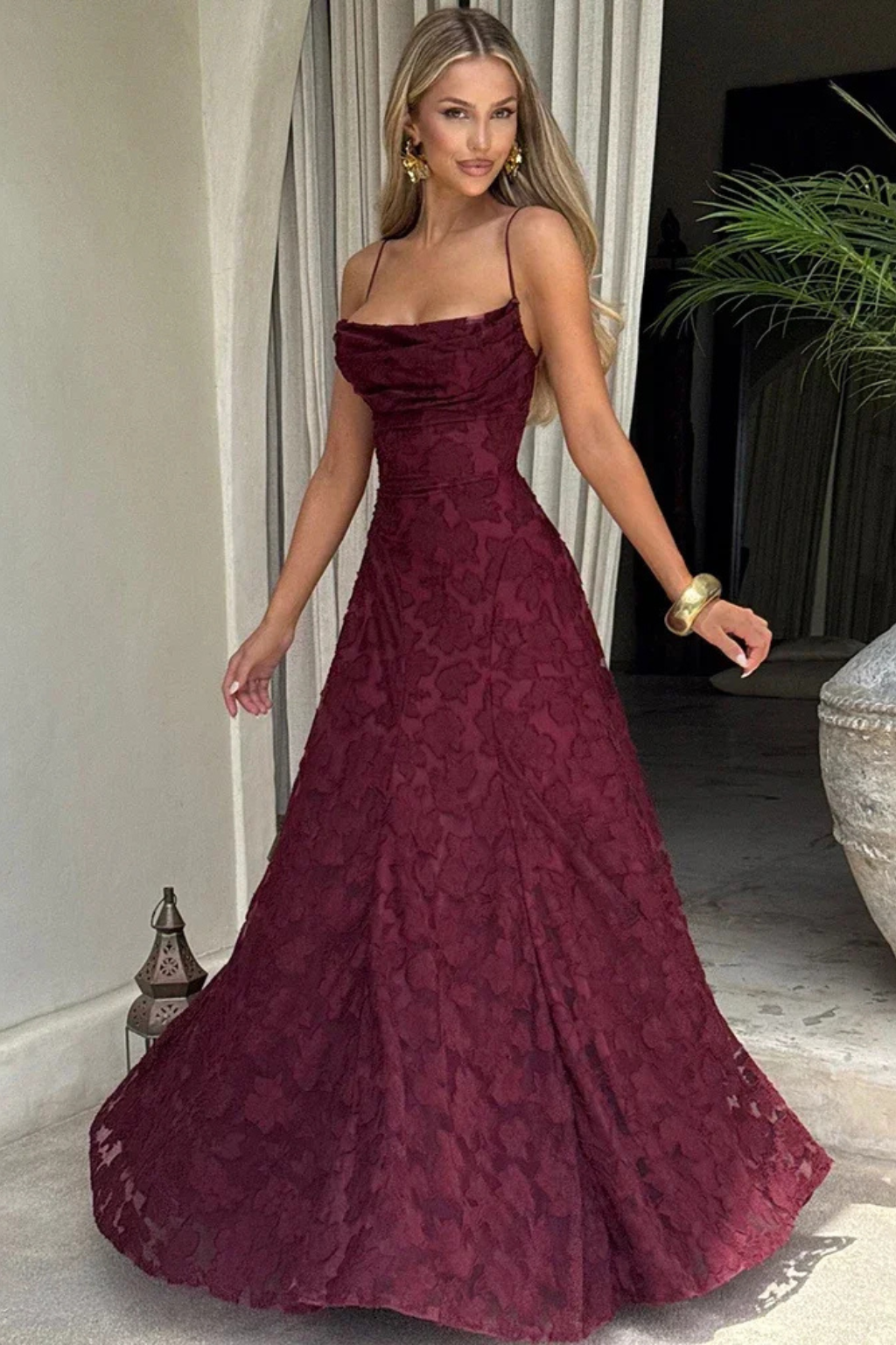 Sleeveless floral print maxi gown for women, featuring a flared skirt & lace-up back, ideal for evening events.