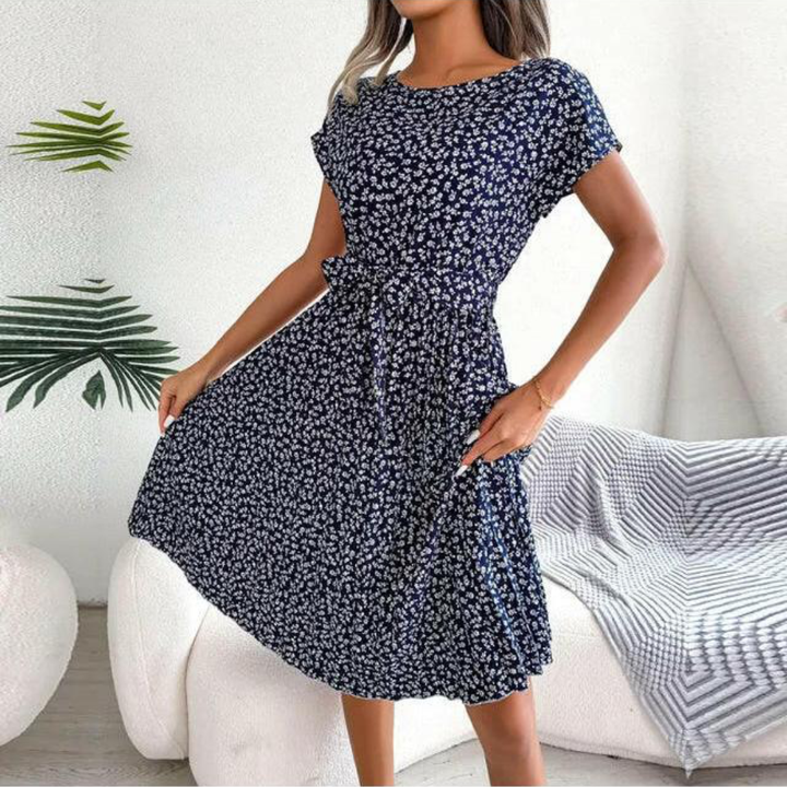 Sophisticated women's floral midi dress with a delicate pleated design. Elegant for day or evening wear.