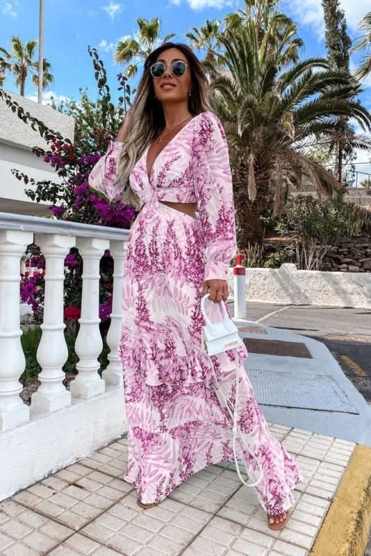Woman wearing a stylish flowy maxi dress outdoors, ideal as a casual summer or vacation dress.