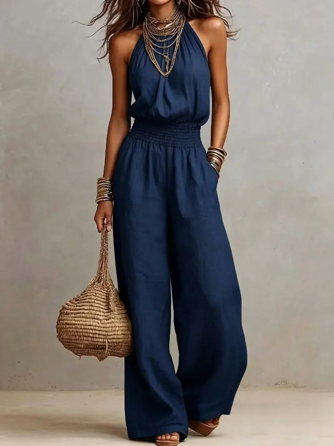 Women's chic flowy wide leg halter neck jumpsuit, a comfortable and elegant piece for summer fashion.