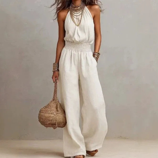 Elegant women's halter neck wide leg jumpsuit with smocked waist, perfect for summer parties & resort wear.