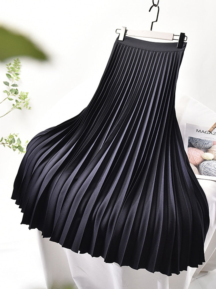 Flowy pleated midi skirt for women, featuring a flattering high waist design for an elegant silhouette.