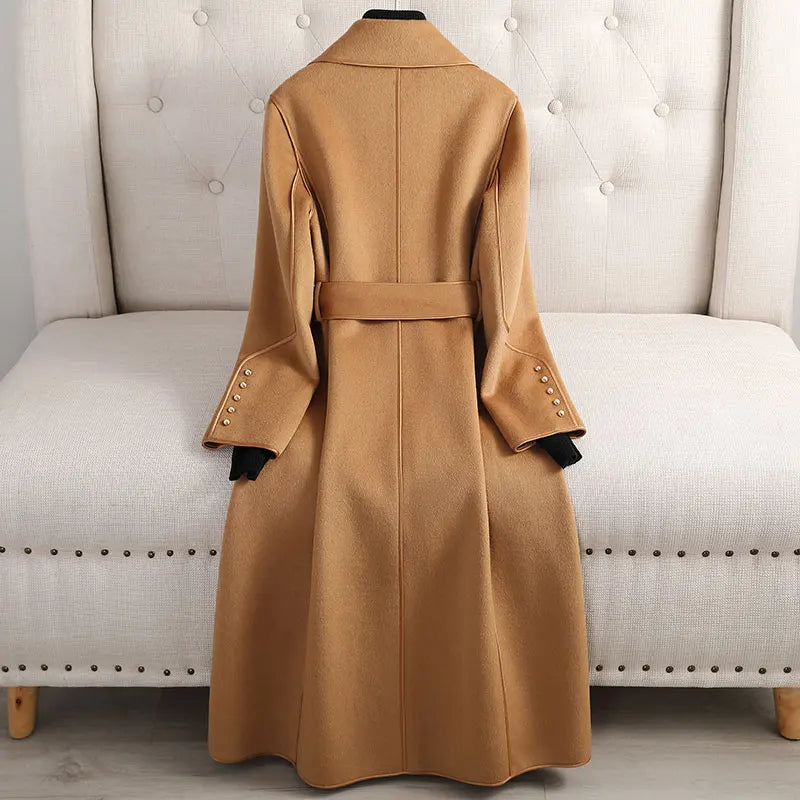Stylish belted women's long trenchcoat, tailored for an elegant look, suitable for formal wear or casual occasions.
