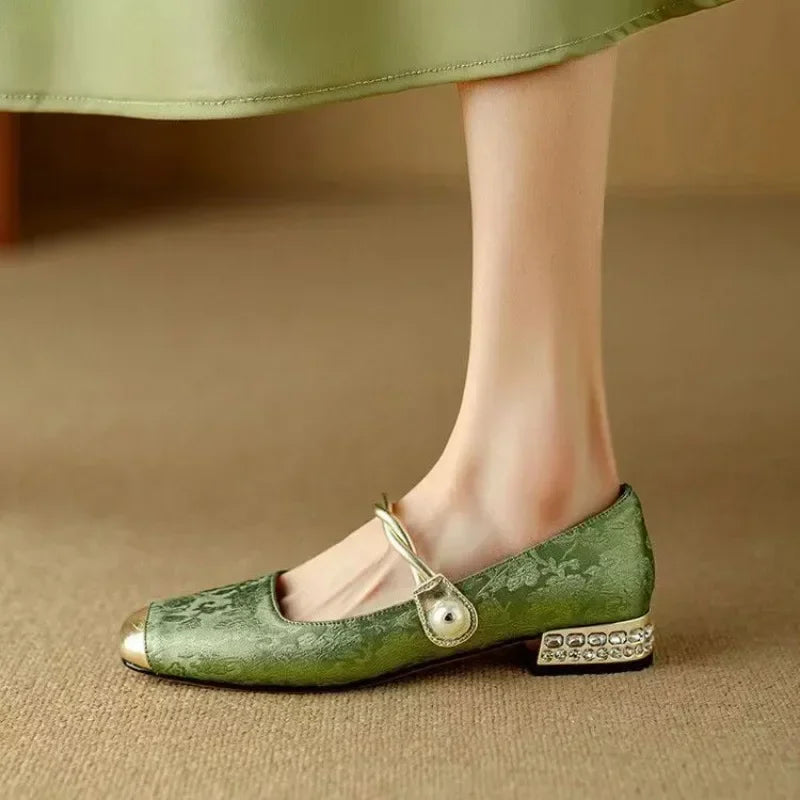 Close-up of delicate pearl strap on chic Women's Mary Jane flats, blending vintage style with modern comfort.