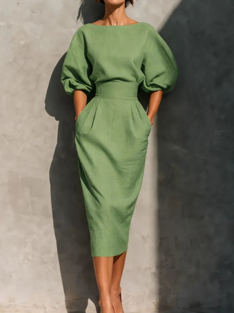 Fashionable women's elegant midi dress, detailed with beautiful pleats & statement lantern sleeves for any occasion.