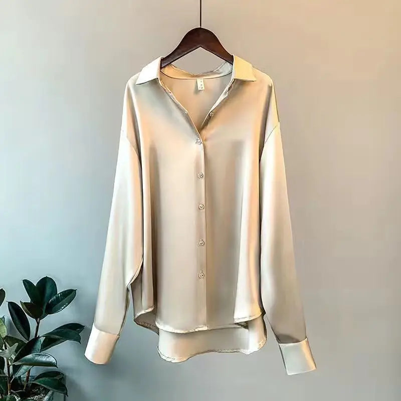 Polished women's flowy oversized shirt. Elegant long-sleeve button-down top for casual luxury and contemporary style.