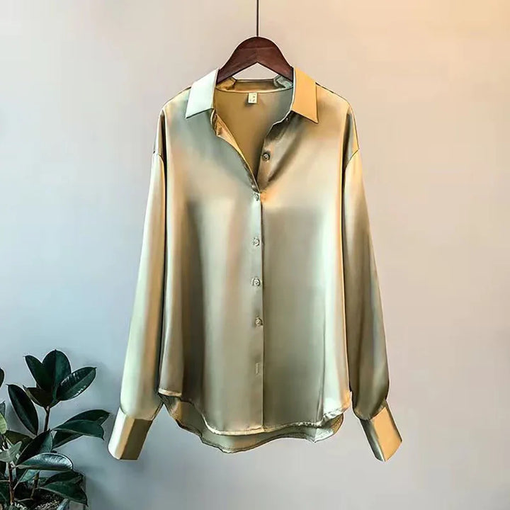 Contemporary women's oversized button-down shirt. Elegant long-sleeve blouse for a sophisticated, versatile look.