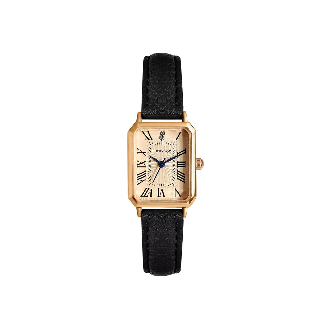 Close-up of women's elegant gold-tone rectangle quartz watch dial with Roman numeral markers.