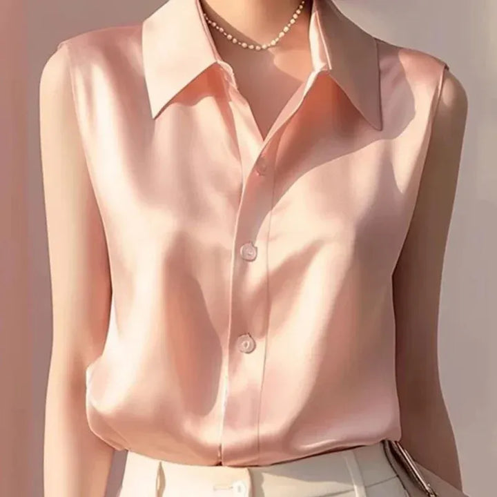 Stylish women's sleeveless button blouse. Versatile tailored collared top, ideal for elegant professional or smart casual fashion.