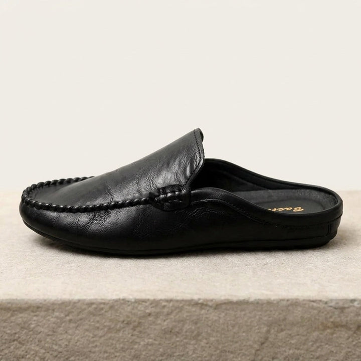 Modern women's open-toe mules. Elegant slip-on flat loafers for summer comfort and effortless casual style.