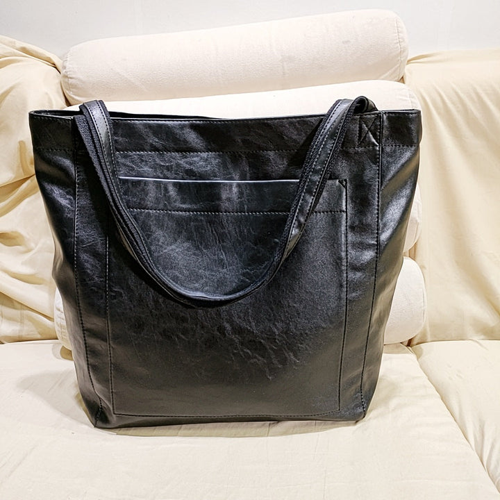 Stylish black soft leather shoulder bag for women; versatile everyday crossbody bag, an elegant & classic fashion accessory.