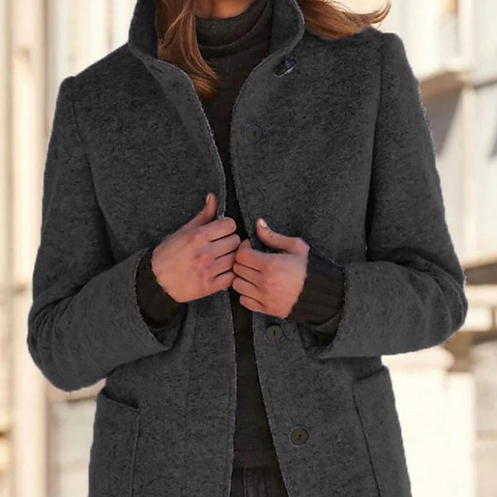 Classic women's fall/winter coat: tailored mid-length with a sleek button closure, offering refined everyday style.