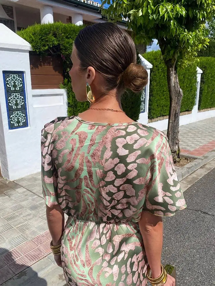 Long elegant women's maxi dress with a sophisticated twist front & V-neck, ideal for formal wear.