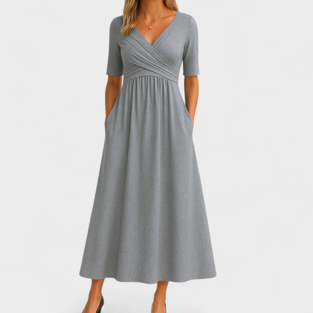 Women's V-neck midi dress with practical pockets and a stylish crossover waist. Ideal work or casual spring dress.