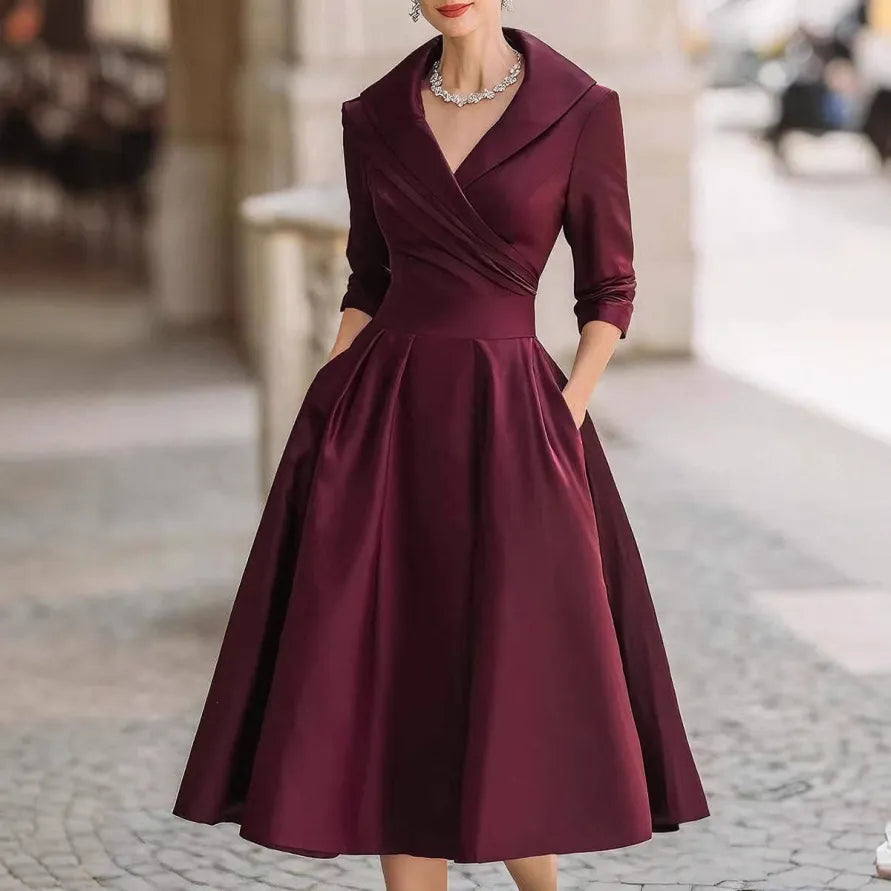 Stylish women's three-quarter sleeve V-neck midi dress featuring practical pockets and elegant design.