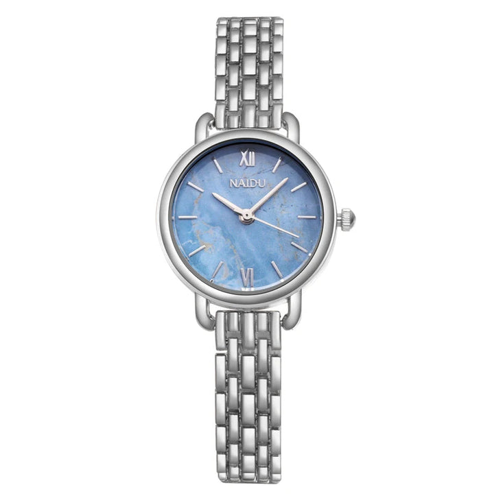 Detailed shot of a women's silver watch with an elegant marble dial & polished stainless steel.