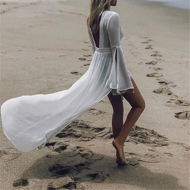 Women's elegant white maxi vacation dress with open back and flare sleeves, ideal for beach or resort.
