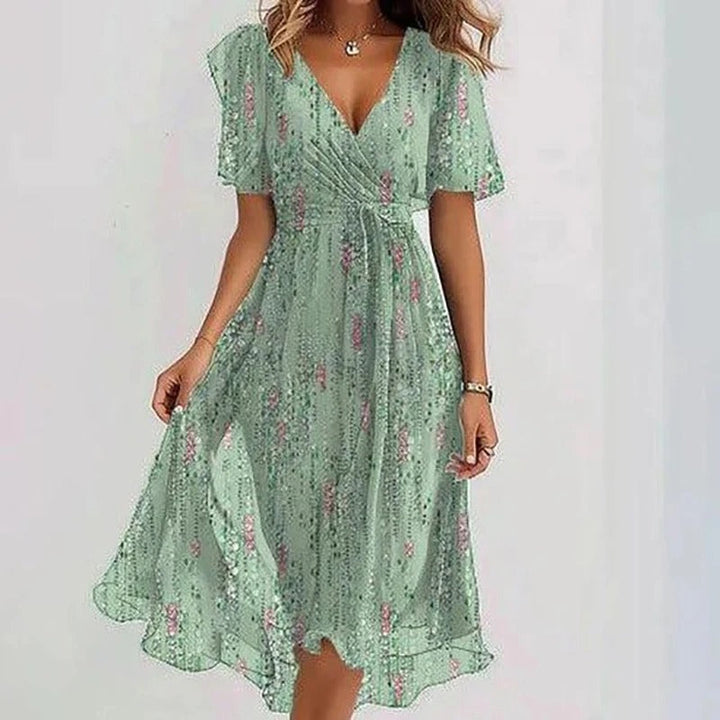 Flowing floral women's midi wrap dress featuring V-neck and flutter sleeves for a romantic summer look.