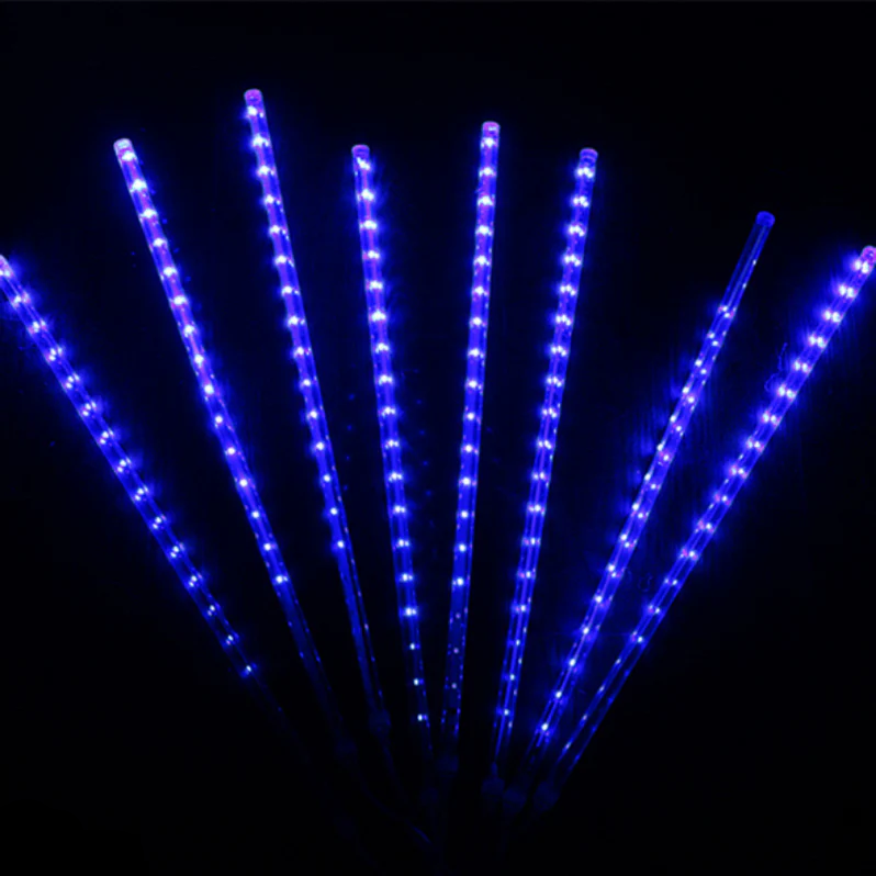 Waterproof LED snowfall projection light for outdoor winter decor, illuminating homes with festive glow.