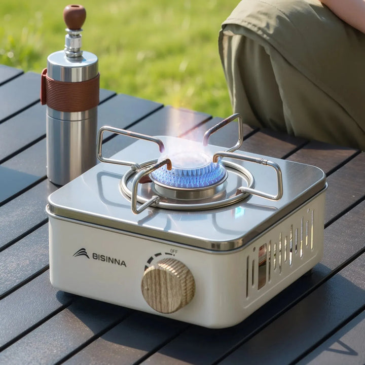 Compact camping stove for backpackers, stainless steel mini foldable gas stove for efficient outdoor cooking.