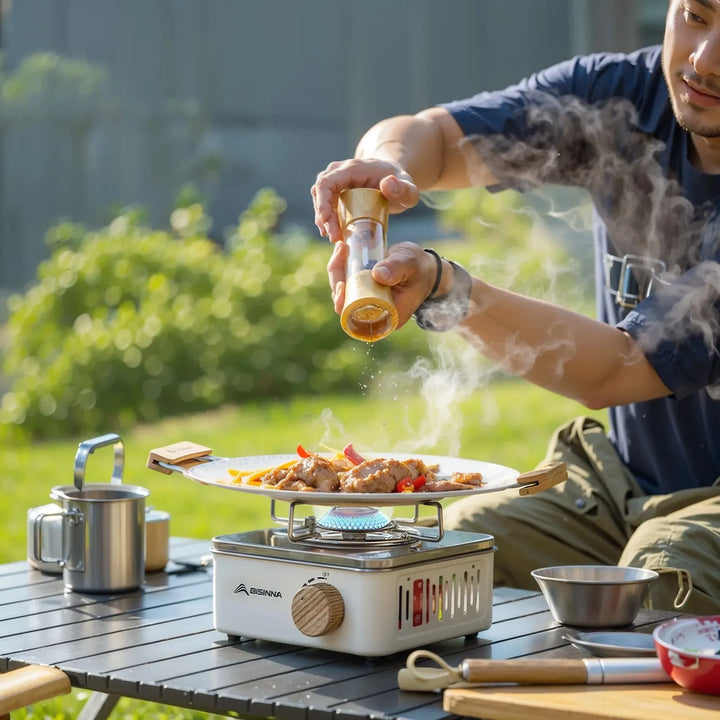 Lightweight mini foldable camping stove, perfect for backpacking, features stable pot support for outdoor meals.