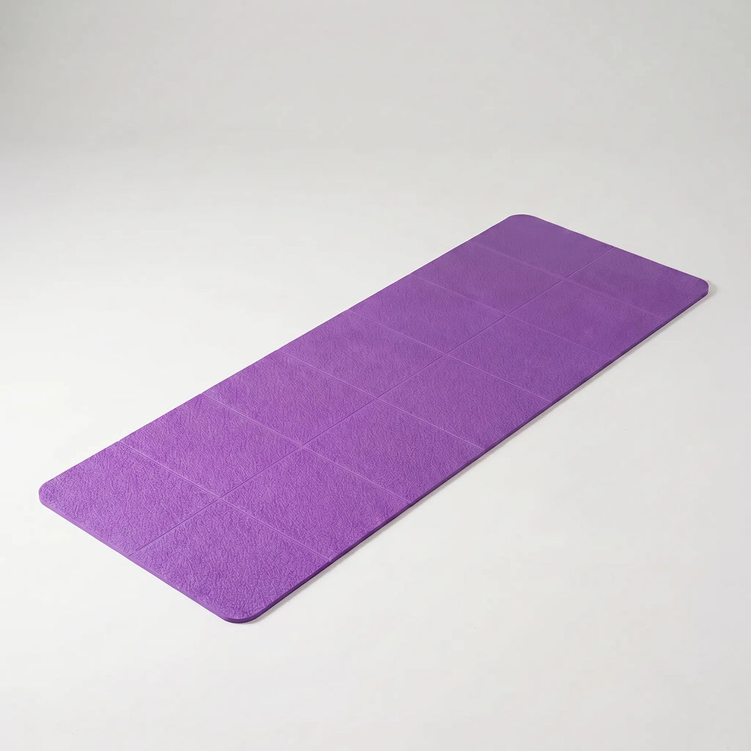 Foldable TPE yoga mat for home workouts & fitness. Non-slip, lightweight & portable for yoga & pilates exercises.