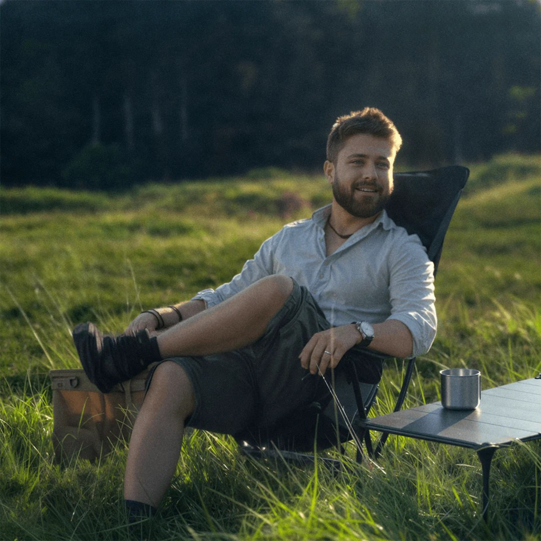 Compact black camping chair for adults, includes durable shoulder bag, great for any trip.