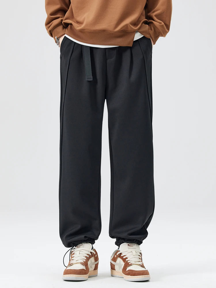 Man wearing wide-leg trousers with a casual t-shirt, demonstrating versatile everyday fashion.