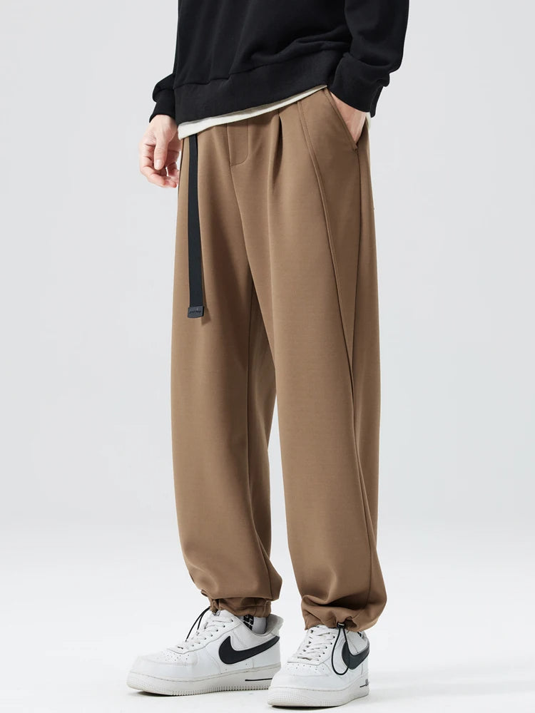 Man walking in comfortable wide-leg trousers, highlighting freedom of movement and relaxed fit.