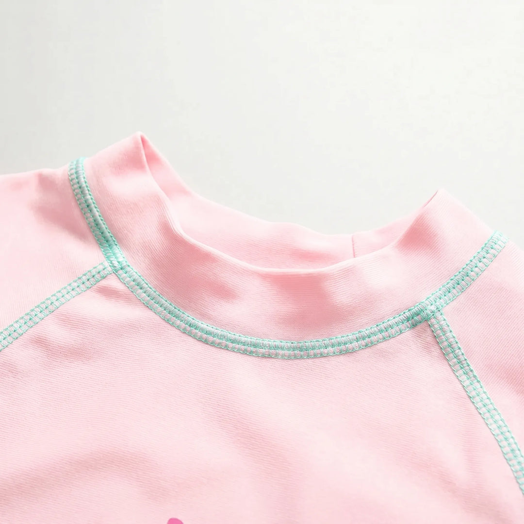 Kids' UPF 50+ long-sleeve rash guard swimwear set, quick-dry fabric for sun-safe beach and pool fun.