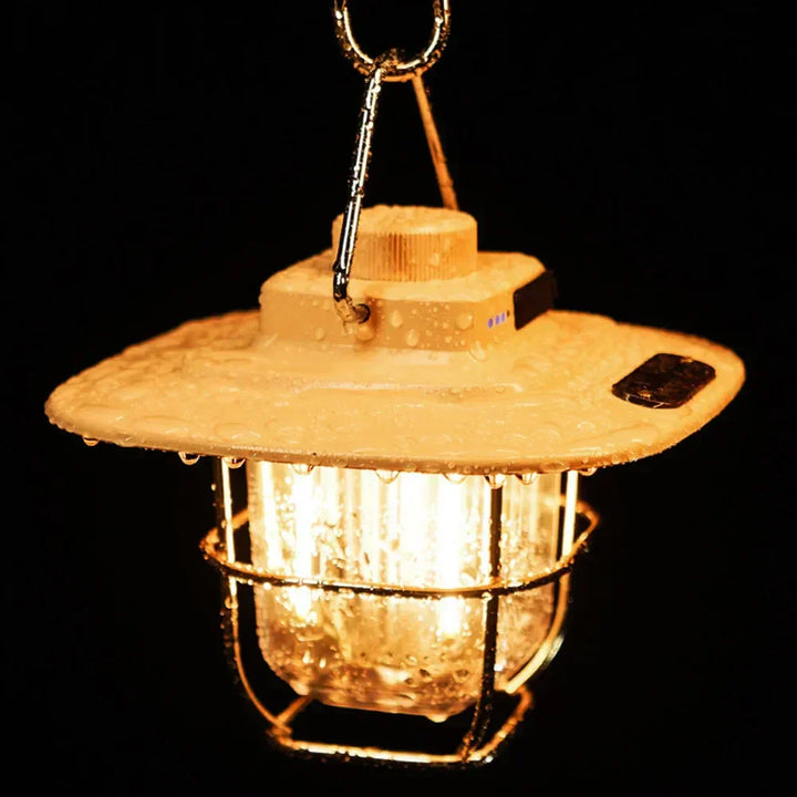 Portable LED vintage camp lantern, rechargeable, creating warm ambiance for any outdoor setting.