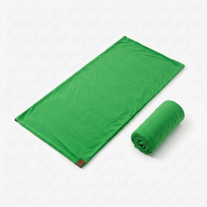 Unisex green lightweight sleeping bag liner for travel, offering comfort and hygiene in outdoor recreation.