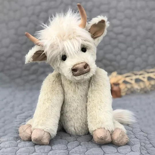 Handmade Scottish Highland cow plush toy, soft brown shaggy fur, cuddly stuffed animal gift for all ages.