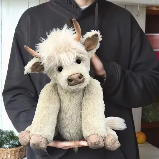 Unisex handmade Scottish Highland cow plush toy, soft stuffed animal with characteristic shaggy brown fur.