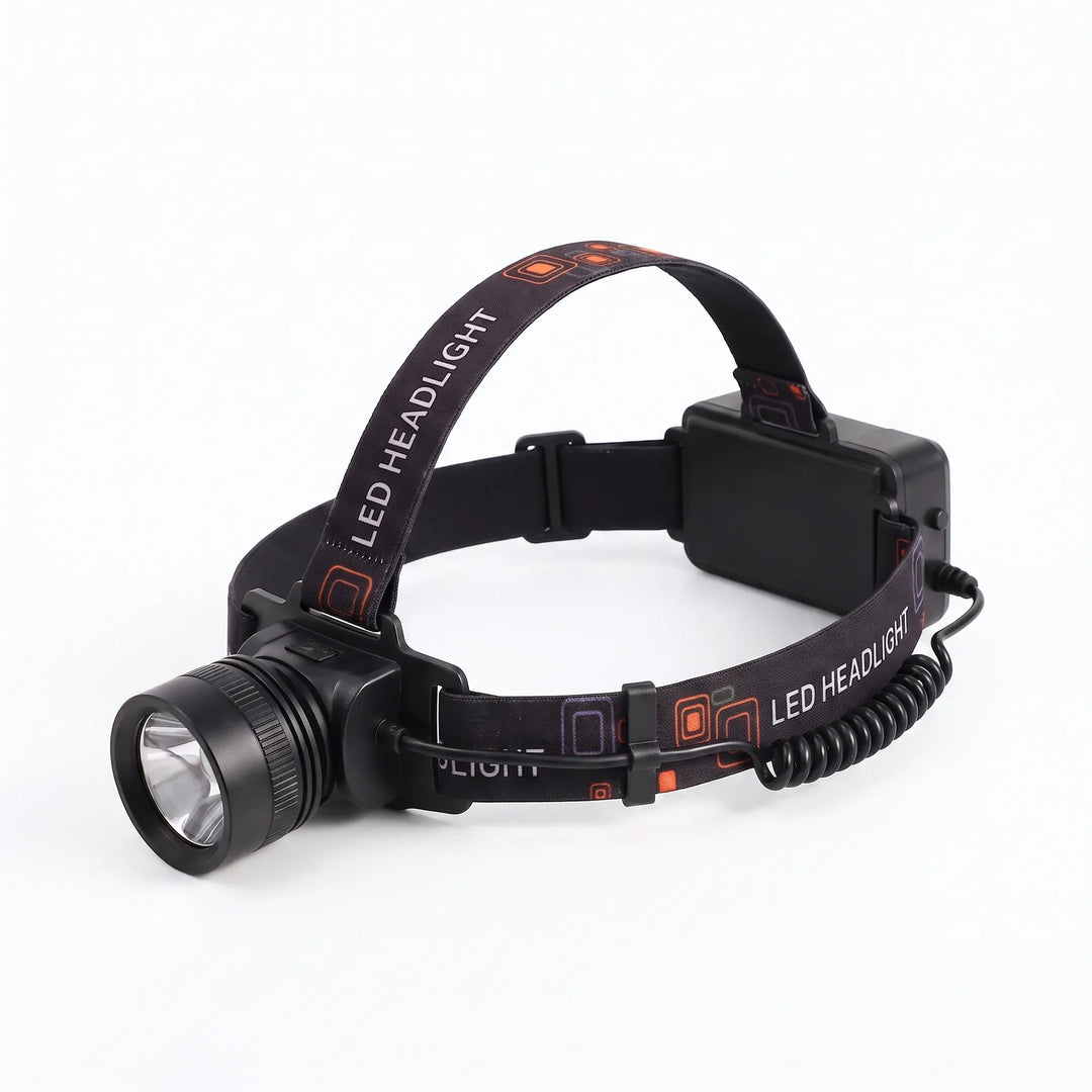 Person wearing a bright LED headlamp, illuminating a dark trail during a night hike. Essential outdoor gear.