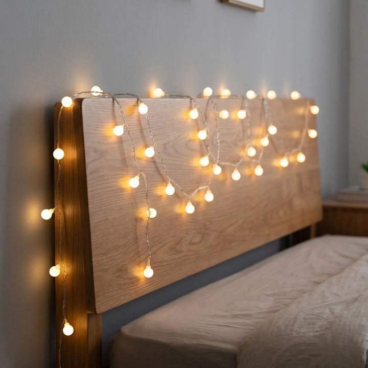 Home LED globe string lights provide ambient lighting for festive room decor. Battery/USB powered fairy lights.