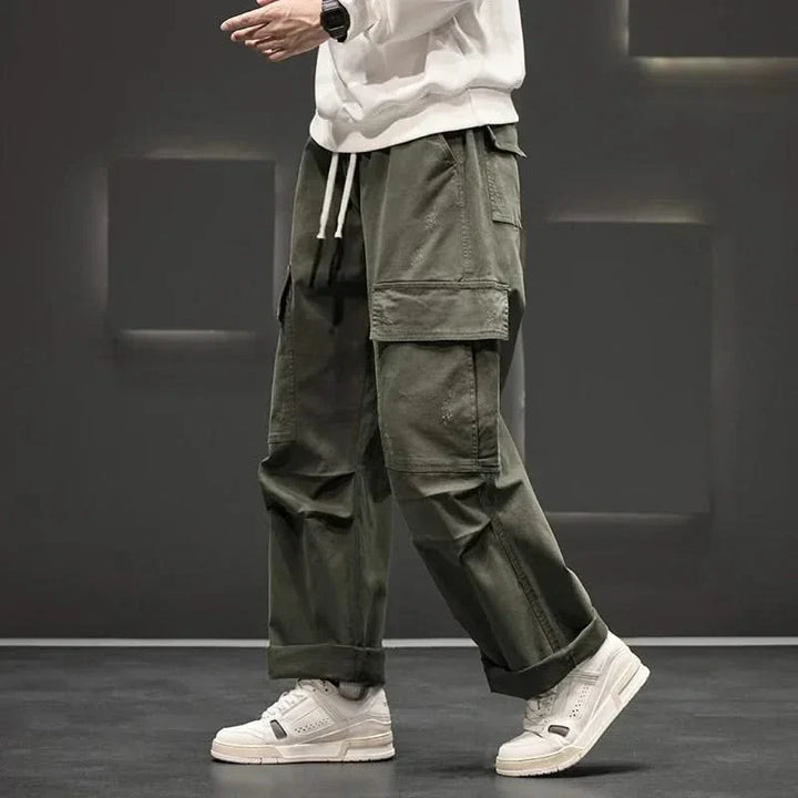 Green men's relaxed fit utility cargo pants, perfect for outdoor activities & everyday wear, featuring a drawstring waist.