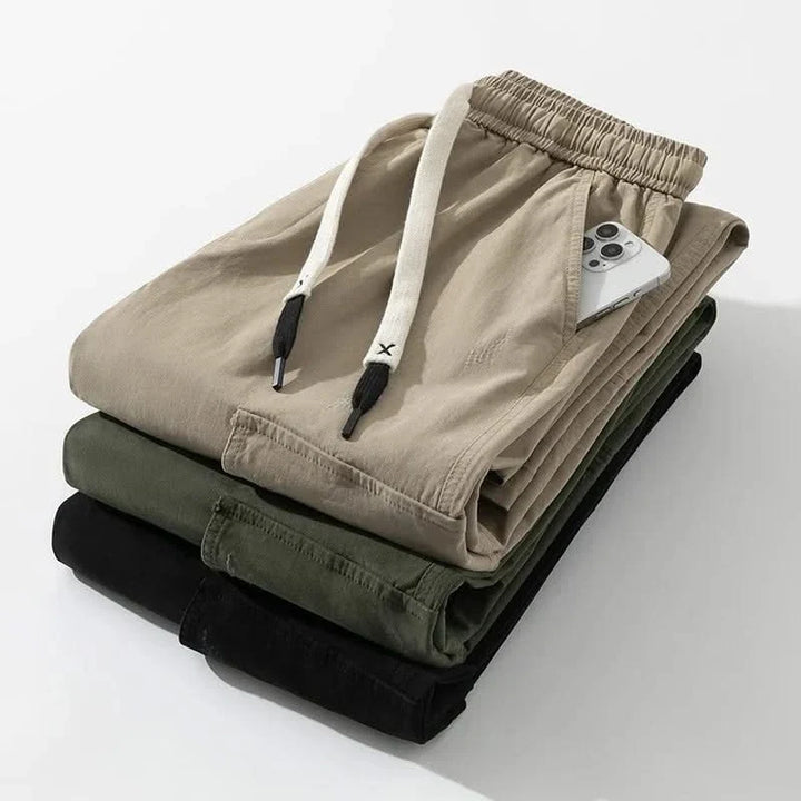 Relaxed fit men's utility cargo pants, designed for comfort and style, featuring a drawstring waist & ample pockets.