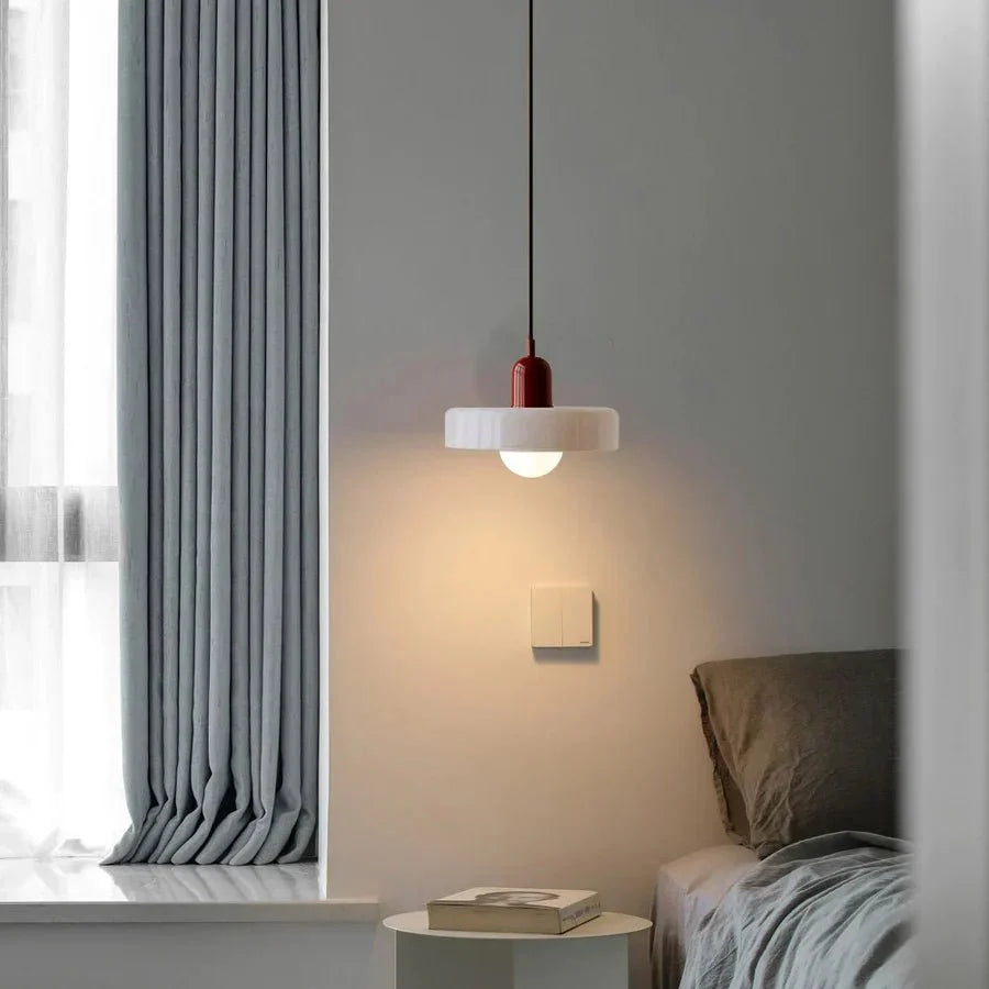 "Lampada a sospensione in vetro trasparente con design minimalista, emette luce soffusa, ideale per interni eleganti."
