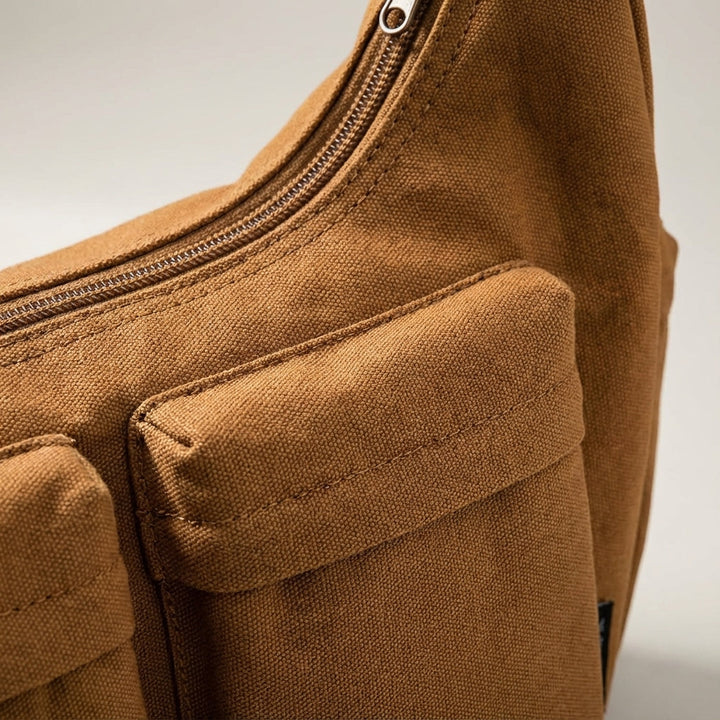 Durable canvas crossbody messenger bag, stylish & practical for unisex everyday use. Robust shoulder carry.